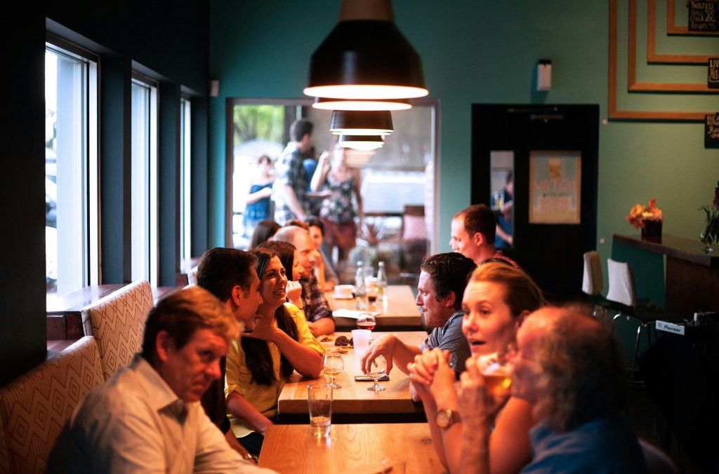 A lively restaurant scene with people sitting at tables, enjoying PST Trolley Bachelorette Parties