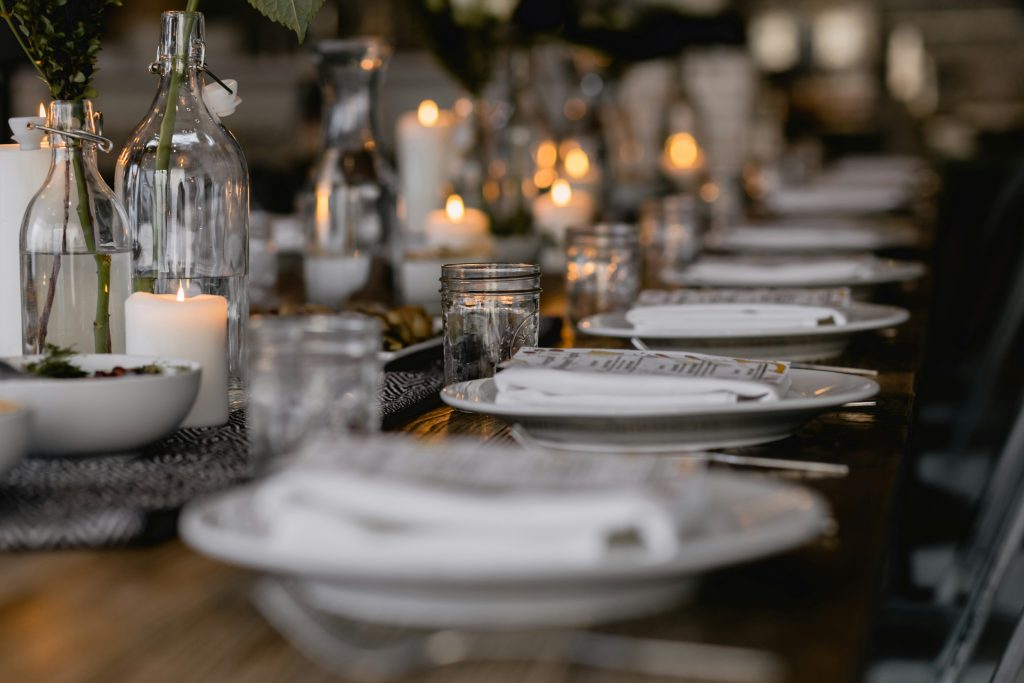 A beautifully arranged table with white plates and place settings for PST Trolley Bachelorette Parties.