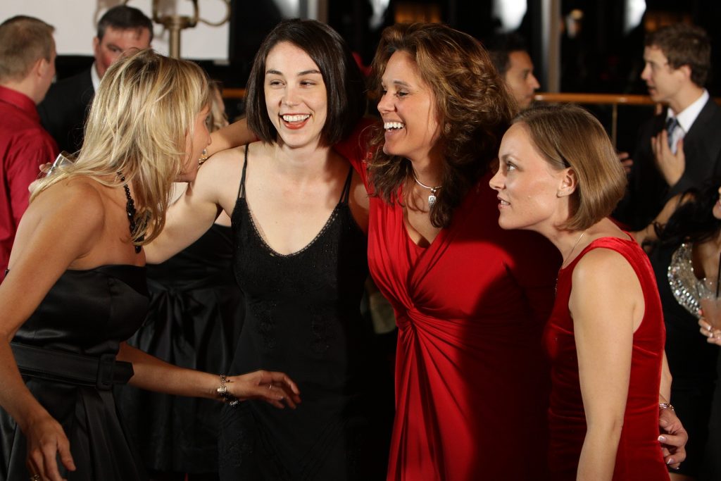 A fun group of women in red and black dresses enjoying a night out together.