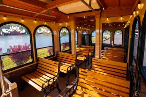 a row of wooden benches sitting next to a window