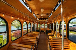 a view of the inside of a bus with benches on the side