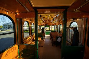 Inside a bus with benches, offering a view of the water - PST Trolley