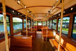 Bus interior with benches and view of the water - PST Trolley