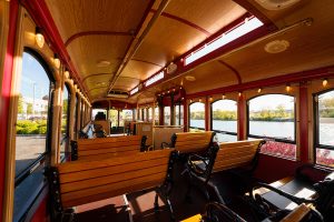 A view of the inside of a bus with benches on the side