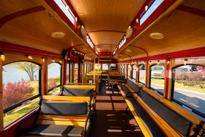 Interior view of a bus with many seats and a window - PST Trolley