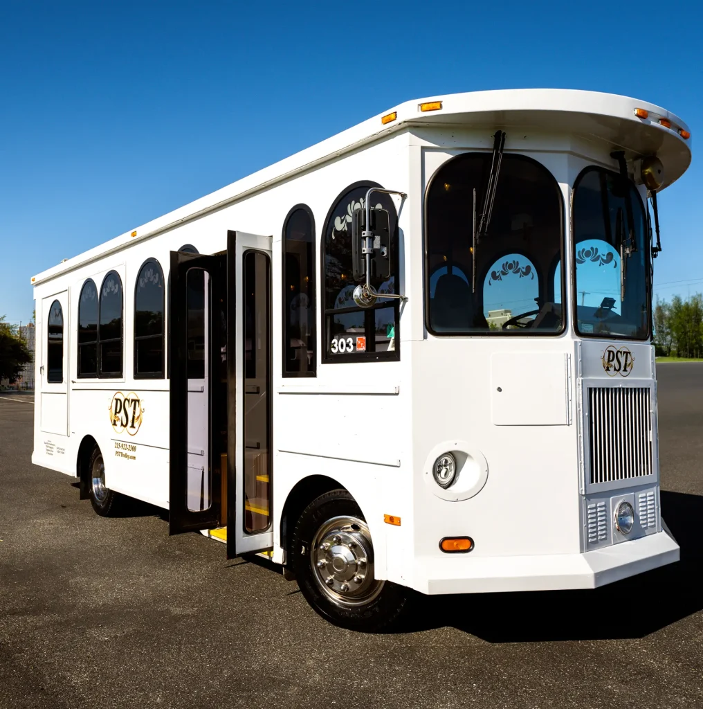white trolley bus on an empty parking space - PST Trolley